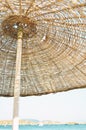 Straw umbrella on the beach and sea background. Summer conÃÂept. Royalty Free Stock Photo